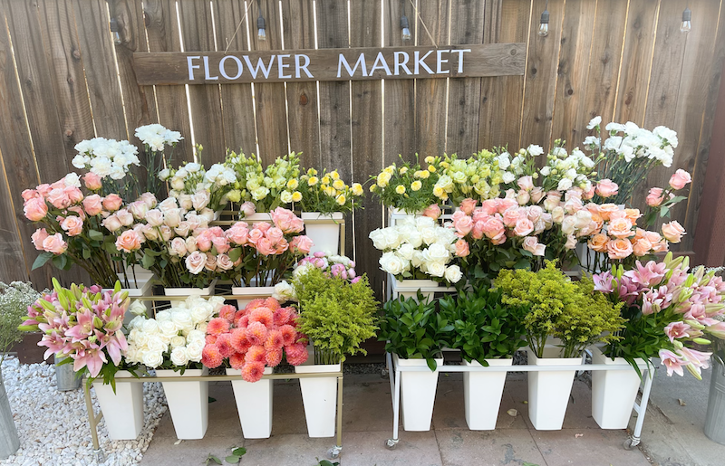 Flower stand setup for a wedding with pastel cut flowers | San Francisco Bay Area.