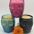 Dia de los Muertos skull candles in pink, blue, and black