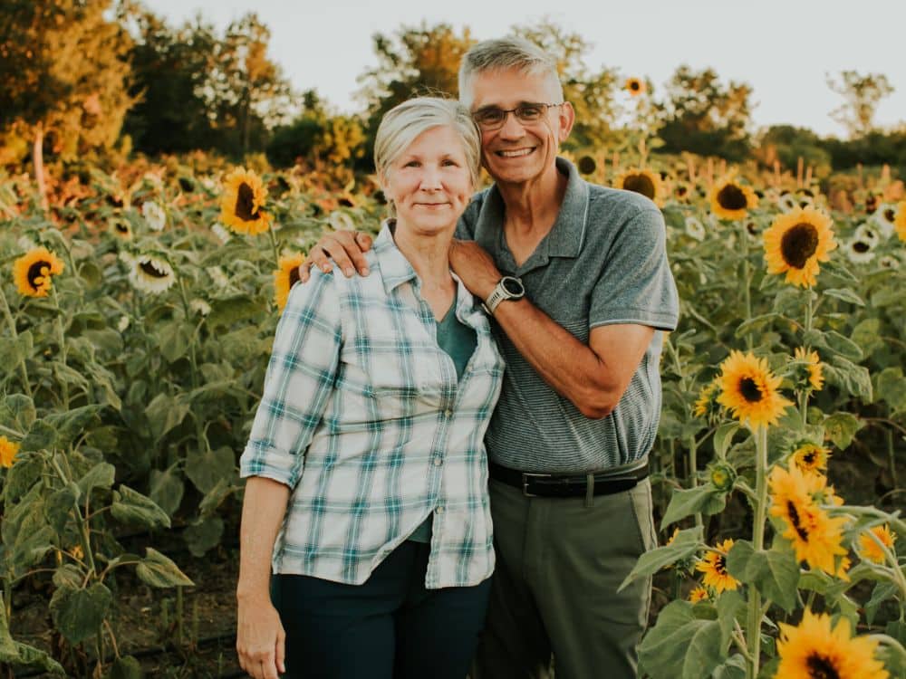 Lisa and Ron, owners of HvH Specialty Growers in Fairfield, California standing amongst the sunflowers