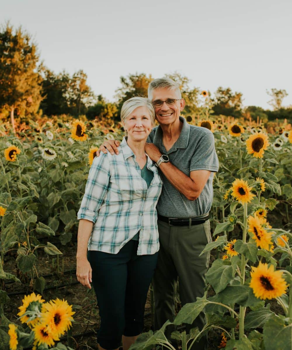 Lisa and Ron, owners of HvH Specialty Growers in Fairfield, California standing amongst the sunflowers