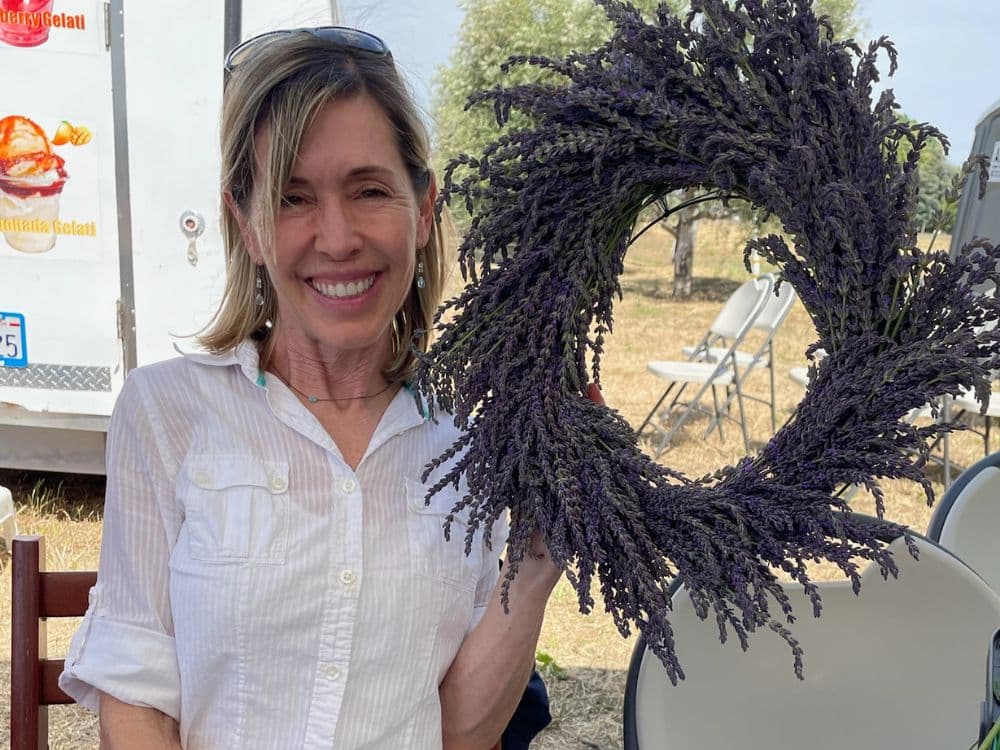 Woman holding a lavender wreath during Lavender Celebration at HvH Specialty Growers in Fairfield, California
