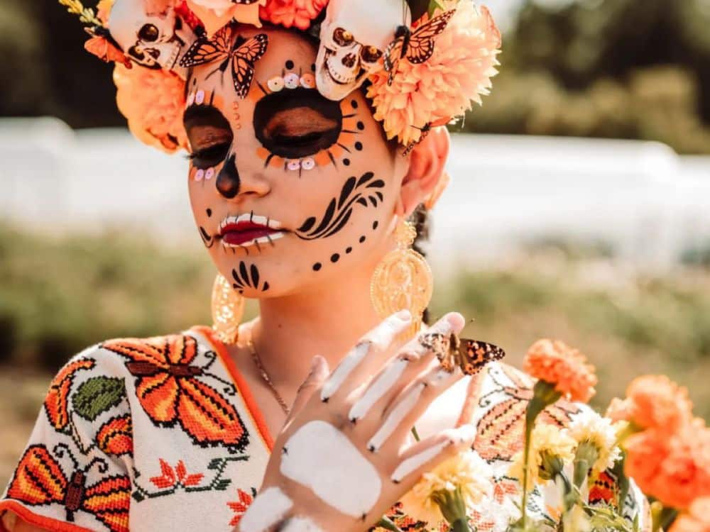 Woman posing dressed for the Monarchs & Marigolds event at HvH Specialty Growers in Fairfield, California