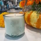 Honey candle in clear glass with embossed milkweed