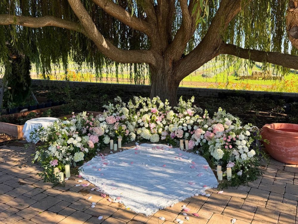 Custom floral arrangement and setting for a proposal under the Weeping Willow at HvH Specialty Growers in Fairfield, California