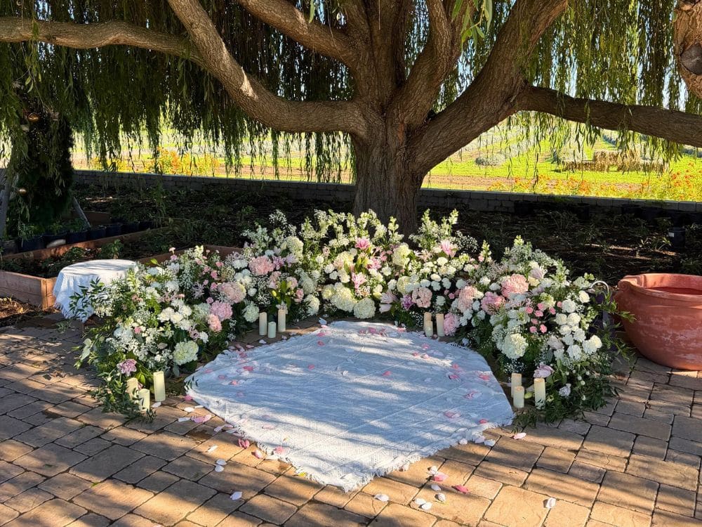 Custom floral arrangement and setting for a proposal under the Weeping Willow at HvH Specialty Growers in Fairfield, California