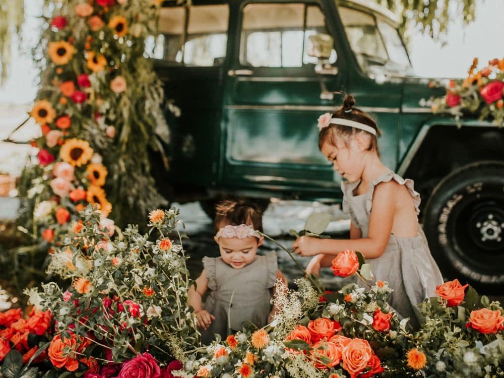 Children looking at flowers during a photo shoot at HvH Specialty Growers in Fairfield, California