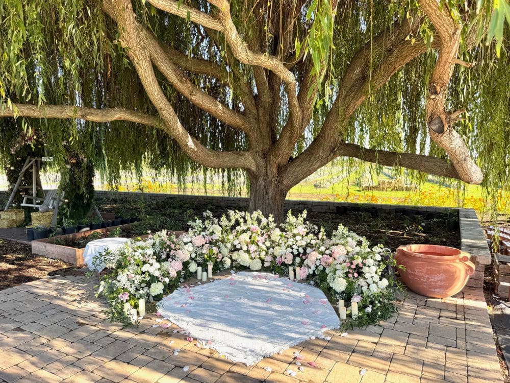 Custom floral arrangement and setting for a proposal under the Weeping Willow at HvH Specialty Growers in Fairfield, California